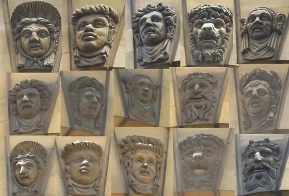 Carved stone heads above the external windows of the Sheldonian Theatre